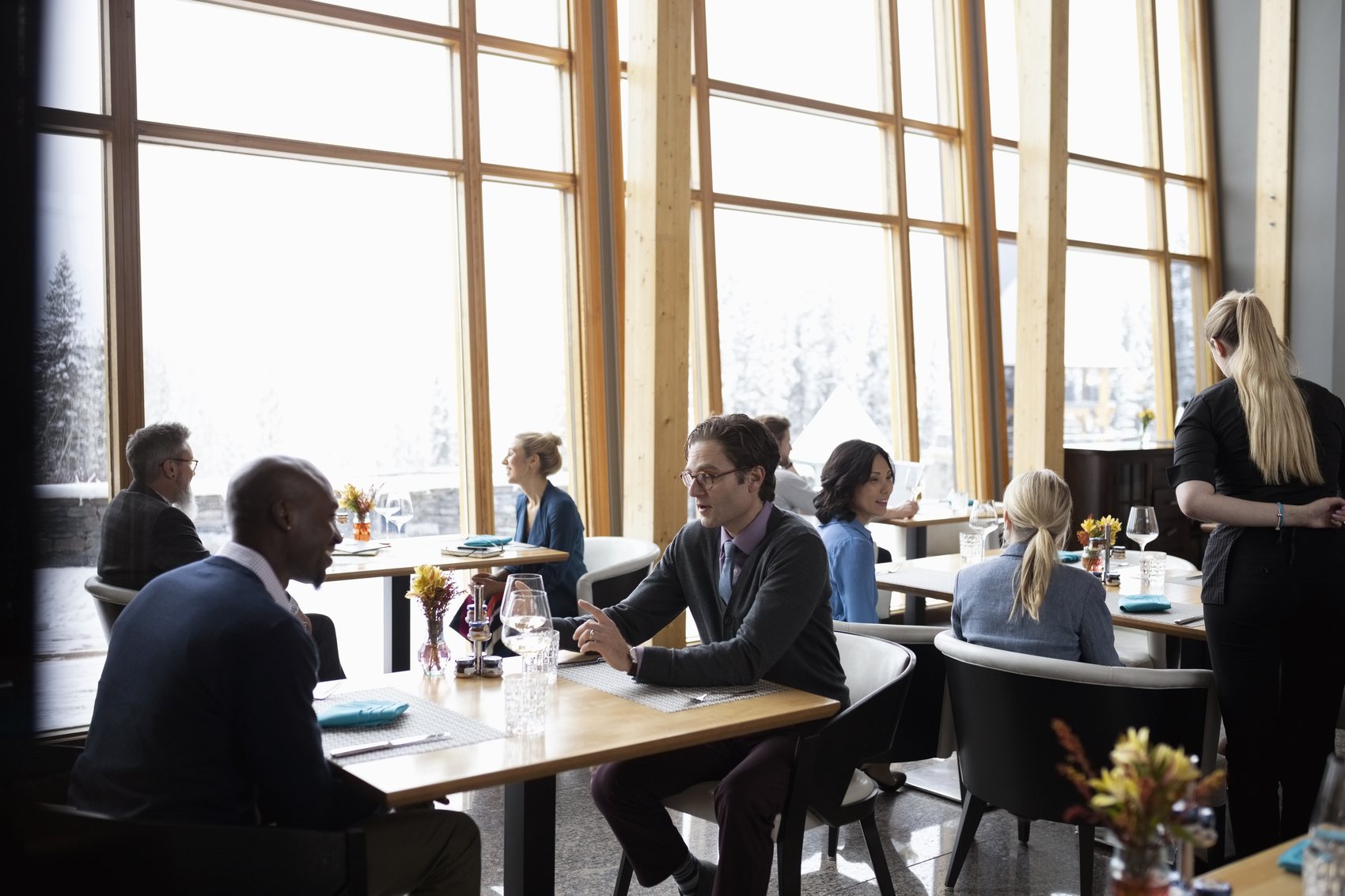 A working meeting around a long table in daylight