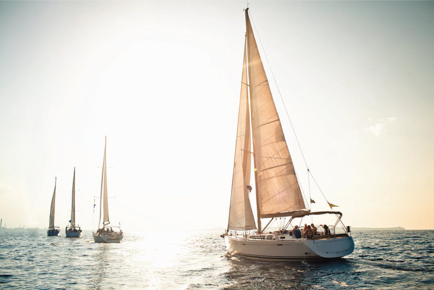 Sailing yachts on open water at first light
