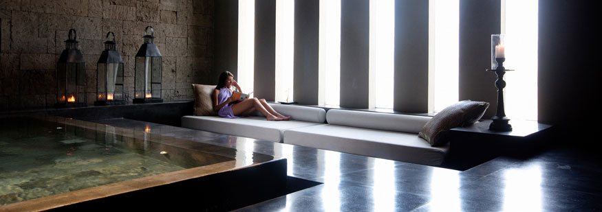 Spa treatment space in low light with a lap pool