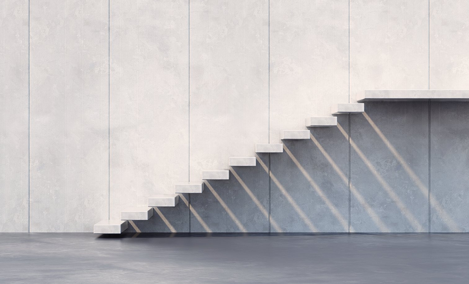 Light falling across a concrete staircase — the ascent Insignia builds for family capital