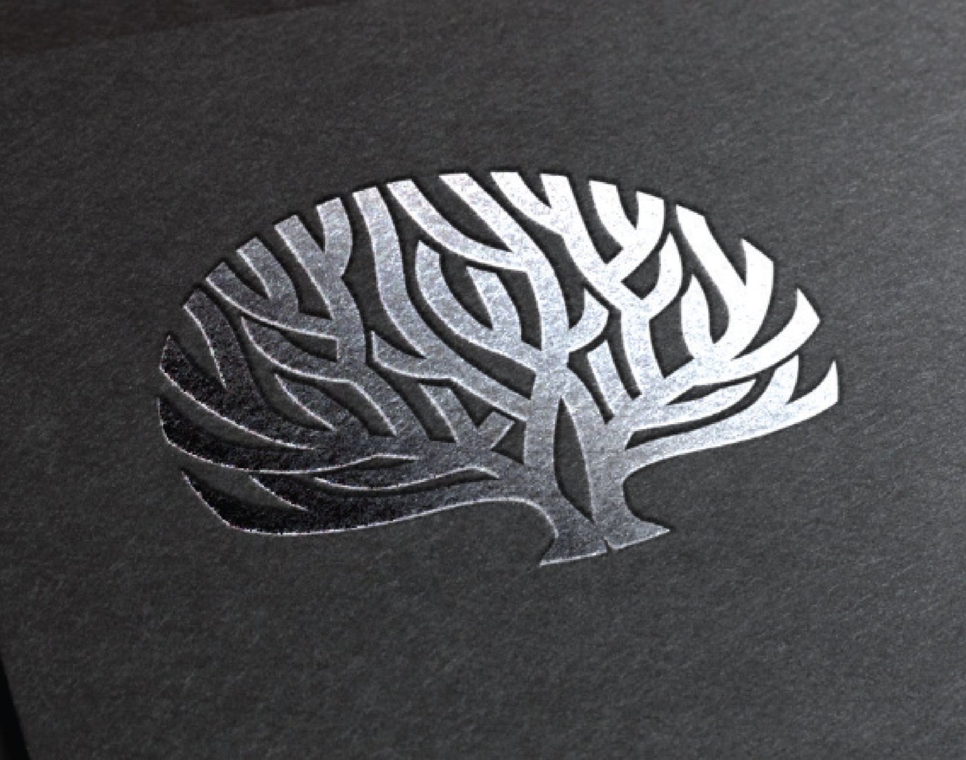 The Insignia coral, blind-embossed in silver foil on the firm's stationery